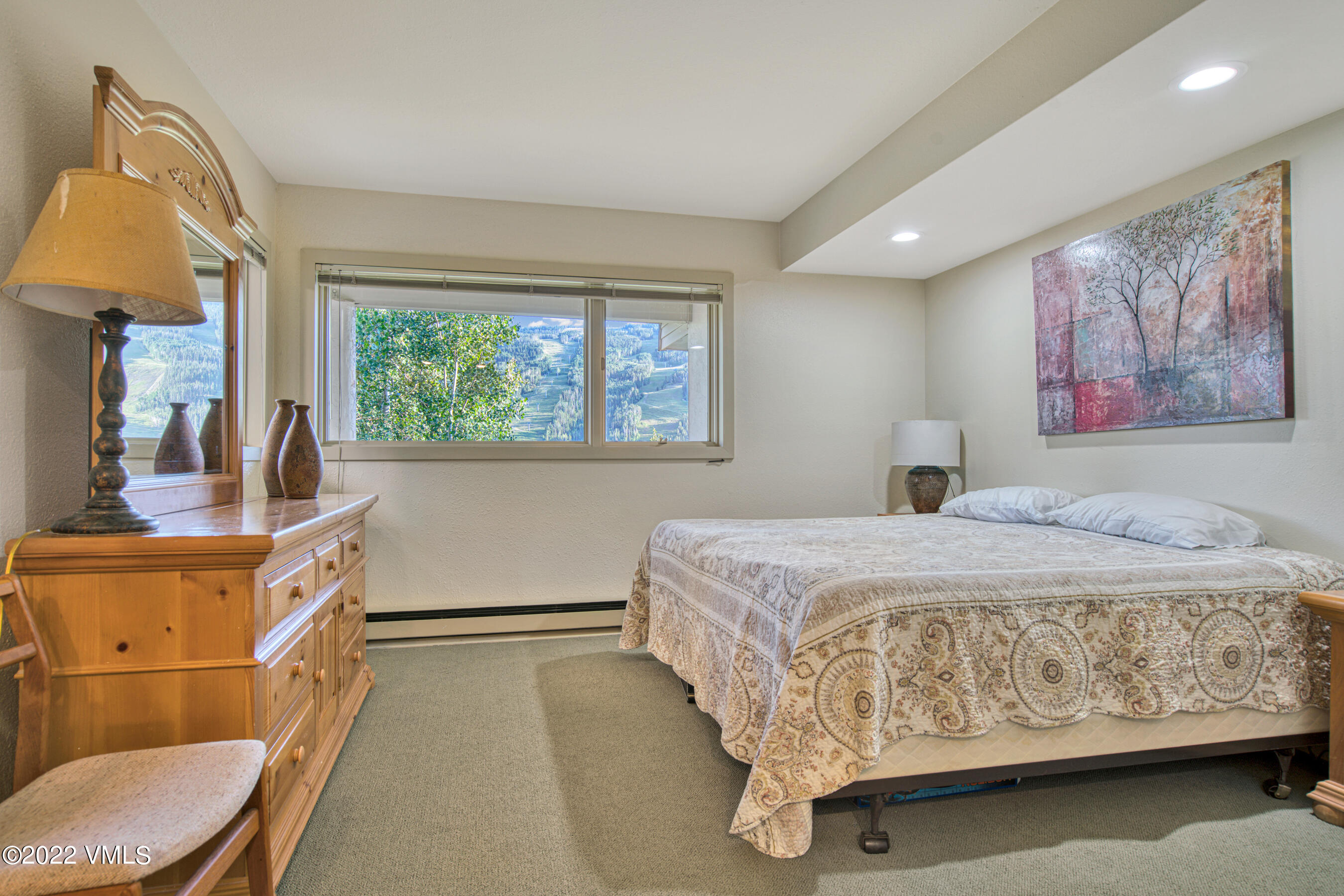 770 Potato Patch Drive, Unit 6 Vail, CO 81657 - Photo 21 of 28 a bedroom with a large bed and a painting on the wall