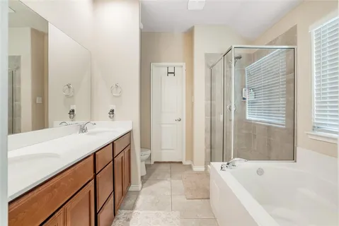 a bathroom with a tub sink and mirror