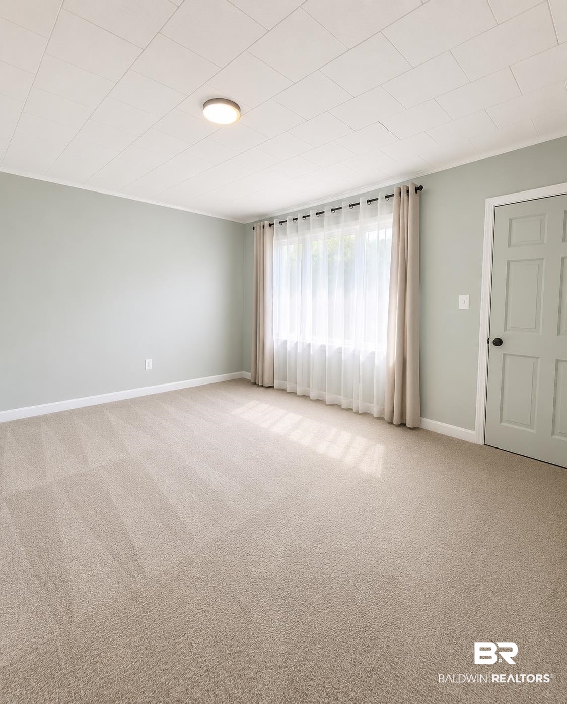 226 Elizabeth Street Evergreen, AL 36401 - Photo 17 of 35 Carpeted room with light green walls and white trim