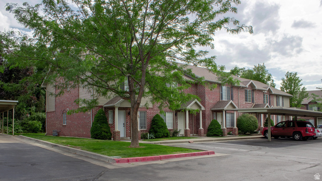 1115 North Main Street Bountiful, UT 84010 - Photo 6 of 17 Brick exterior townhome with covered entryways and a mature tree providing shade