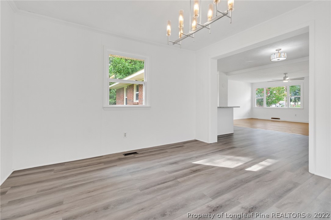 77 Hiawatha Road Pembroke, NC 28372 - Photo 13 of 30 an empty room with wooden floor and windows