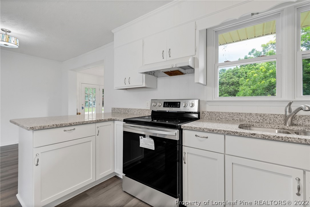 77 Hiawatha Road Pembroke, NC 28372 - Photo 18 of 30 a kitchen with granite countertop white cabinets and a stove
