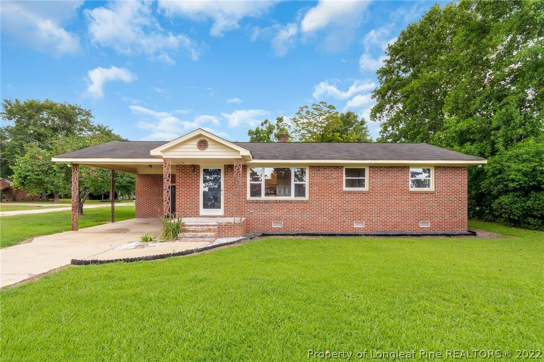 77 Hiawatha Road Pembroke, NC 28372 - Photo 2 of 30 a front view of a house with a garden and yard