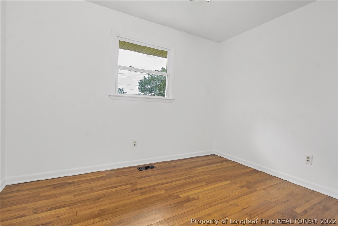 77 Hiawatha Road Pembroke, NC 28372 - Photo 22 of 30 an empty room with wooden floor and window