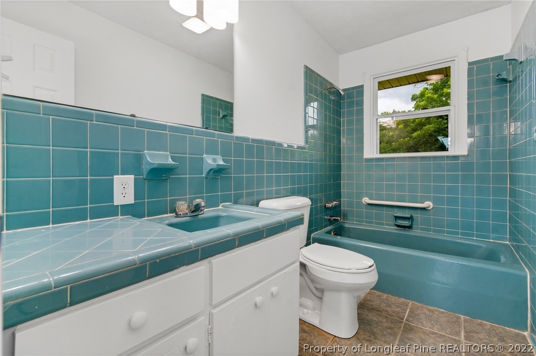 77 Hiawatha Road Pembroke, NC 28372 - Photo 25 of 30 a bathroom with a sink a toilet and a mirror