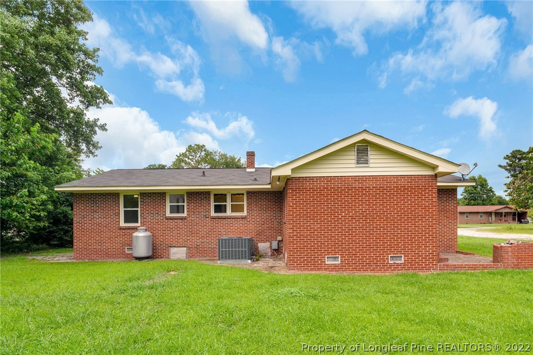 77 Hiawatha Road Pembroke, NC 28372 - Photo 28 of 30 a front view of house with yard and trees in the background