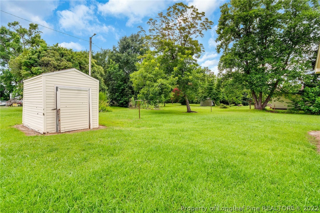77 Hiawatha Road Pembroke, NC 28372 - Photo 30 of 30 a backyard of a house with a garden and entertaining space