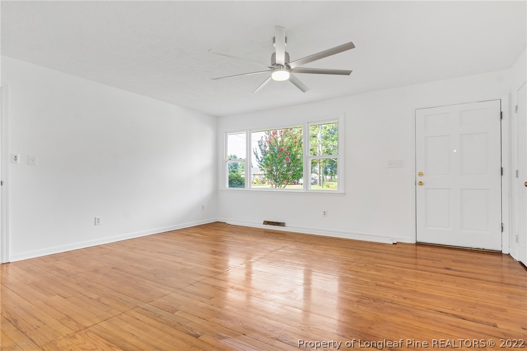 77 Hiawatha Road Pembroke, NC 28372 - Photo 6 of 30 an empty room with wooden floor fan and windows