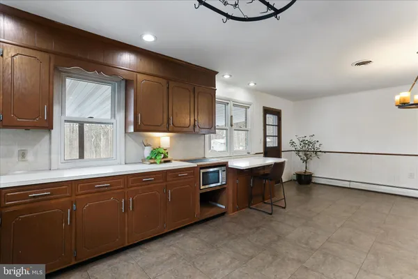 a kitchen with stainless steel appliances a refrigerator and a stove top oven