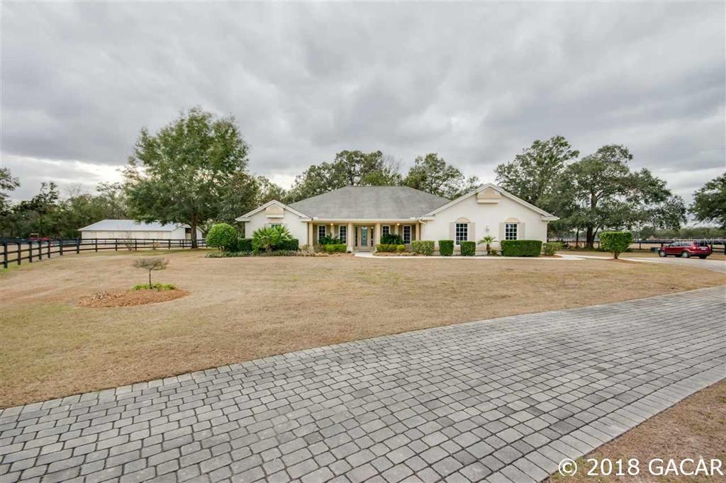 a view of house with outdoor space and sitting area