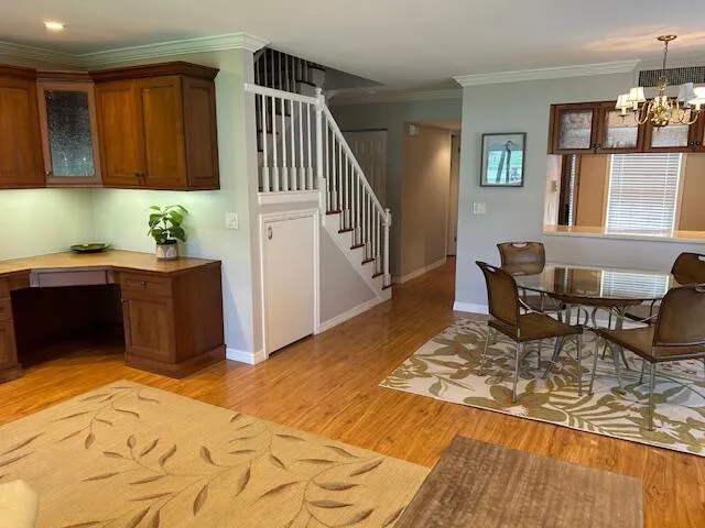 a living room with stainless steel appliances kitchen island granite countertop furniture wooden floor and a window