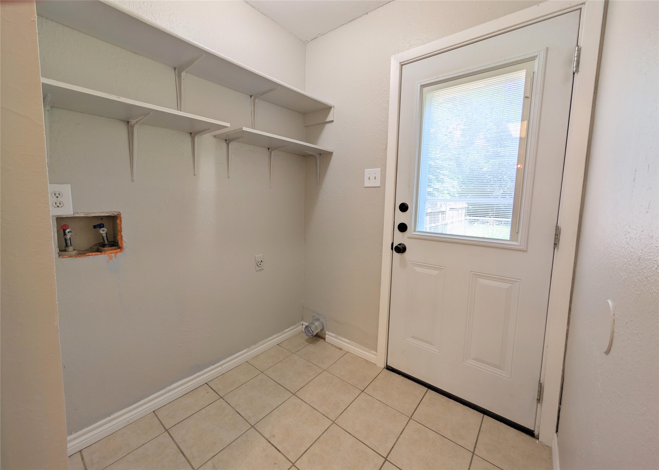 12601 Turtle Rock Road, Unit B Austin, TX 78729 - Photo 15 of 20 Laundry Room and back door is through the Kitchen. Electric washer and dryer connections.