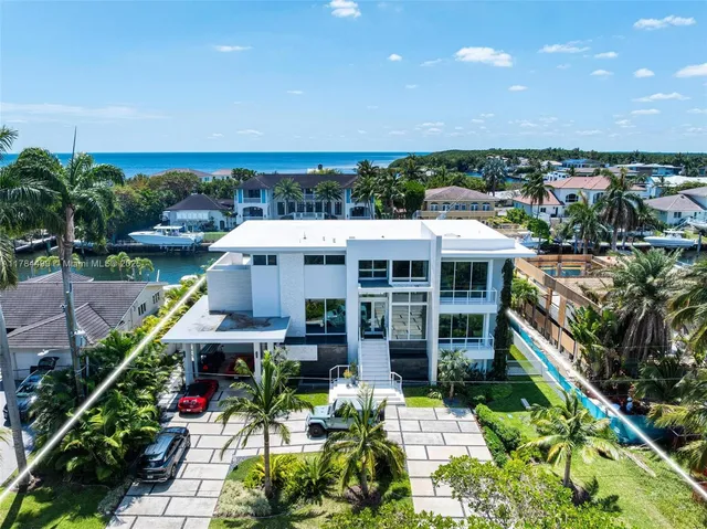 a front view of a house with swimming pool and seating