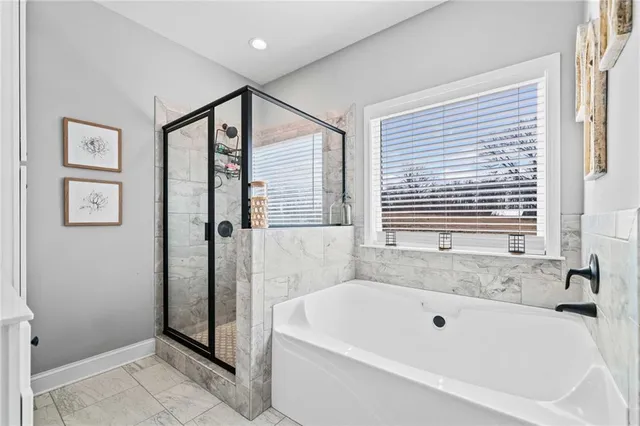 a bathroom with a bathtub and a shower