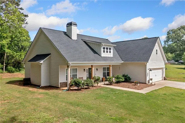 a front view of house with yard patio and fire pit