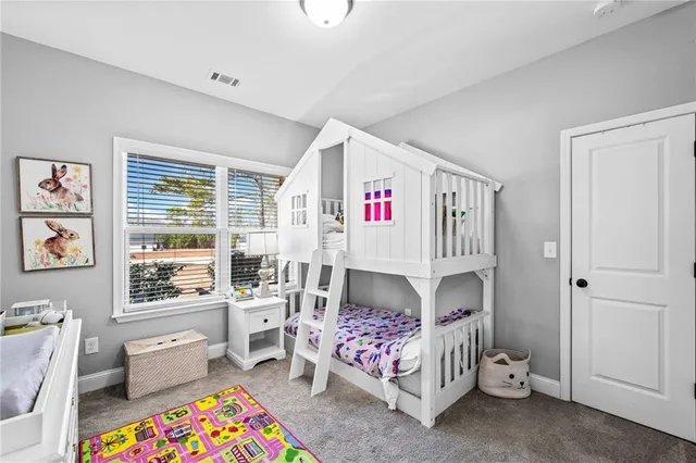 a bed room with a bed and a chair