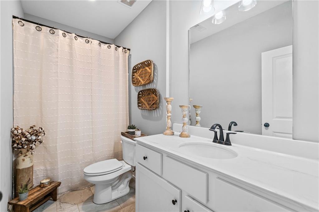 104 Federal Path Temple, GA 30179 - Photo 24 of 32 a bathroom with a toilet sink and mirror