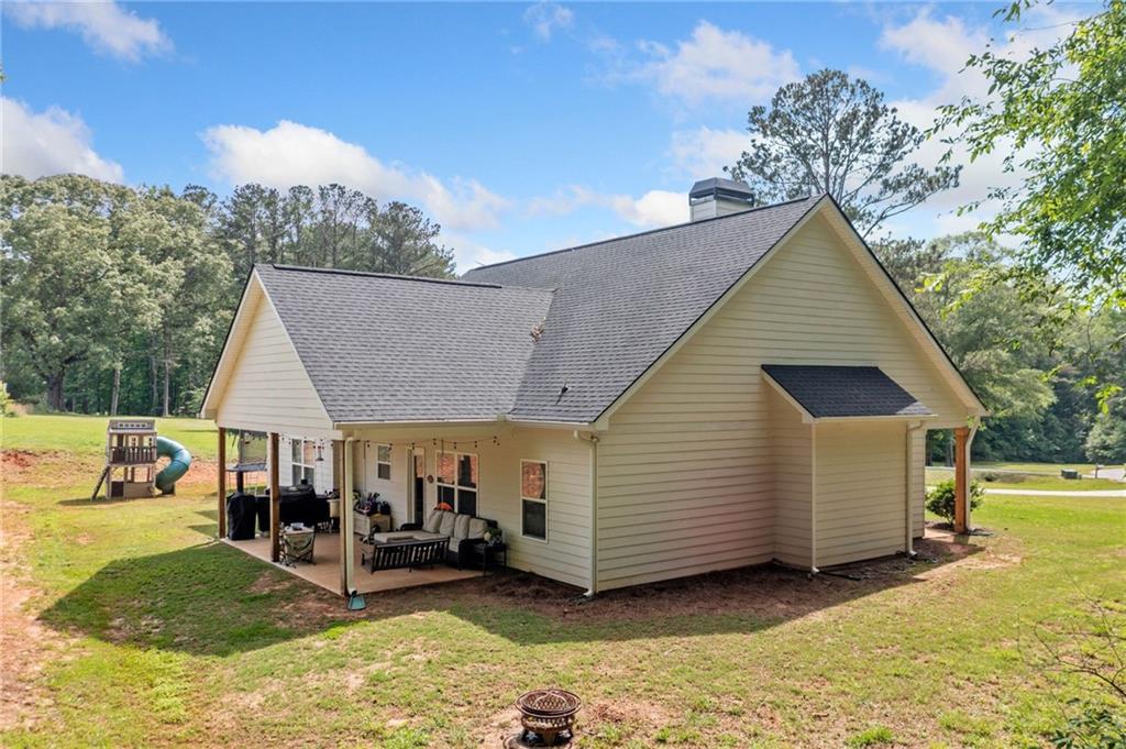 104 Federal Path Temple, GA 30179 - Photo 27 of 32 a view of a house with a yard chairs and iron fence
