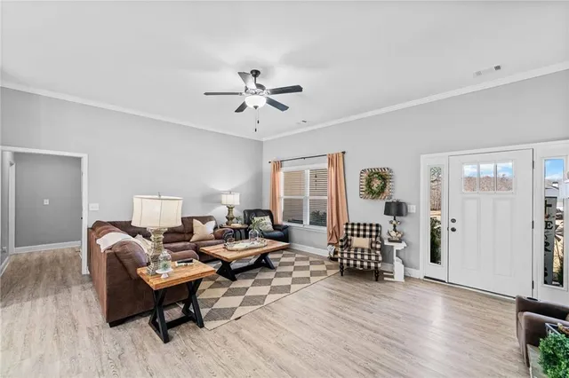 a living room with furniture and wooden floor