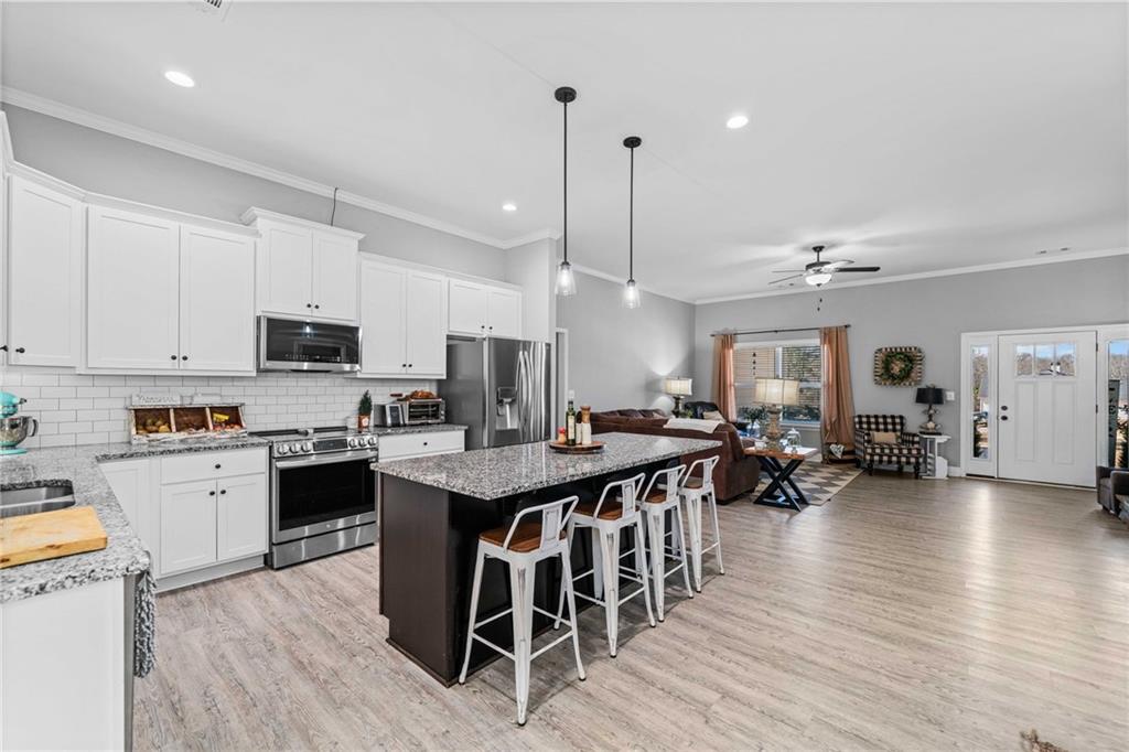 104 Federal Path Temple, GA 30179 - Photo 8 of 32 a large kitchen with stainless steel appliances lots of counter space dining table and chairs