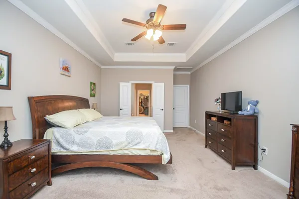 a spacious bedroom with a bed and a large window