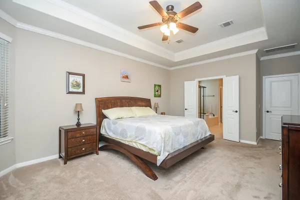 a bedroom with a bed and a tv on dresser