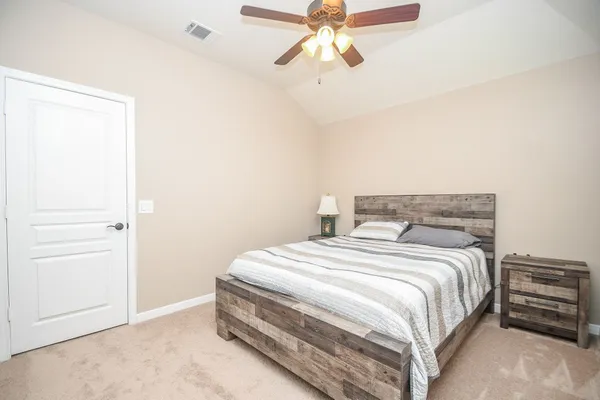 a bedroom with a bed and a chandelier