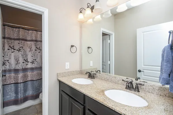 a bathroom with a sink vanity and a mirror