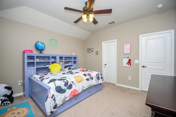 a bed room with a bed and a chandelier