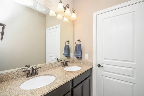 a bathroom with a sink vanity and a mirror