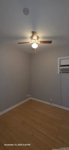 a view of a room with wooden floor