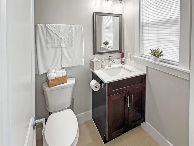 a bathroom with a toilet sink and mirror