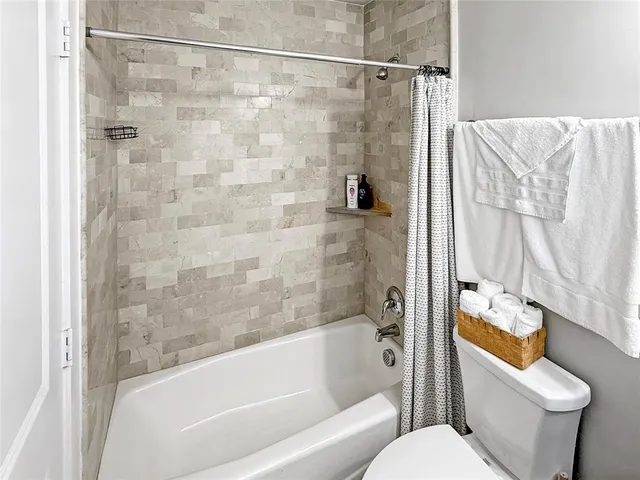 a bathroom with a shower and a toilet