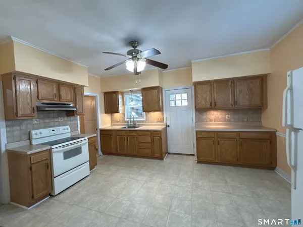 a kitchen with stainless steel appliances a stove sink and refrigerator