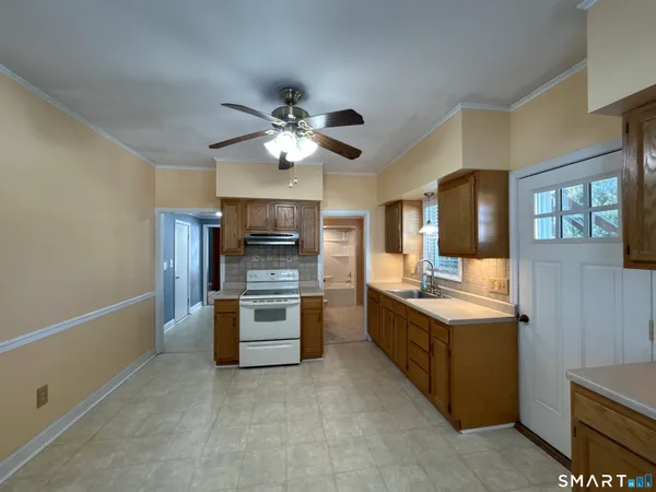 a kitchen with stainless steel appliances a sink stove and refrigerator
