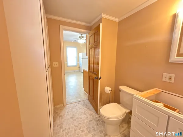 a bathroom with a toilet and a shower
