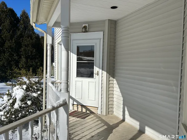 a view of balcony with wooden floor and fence