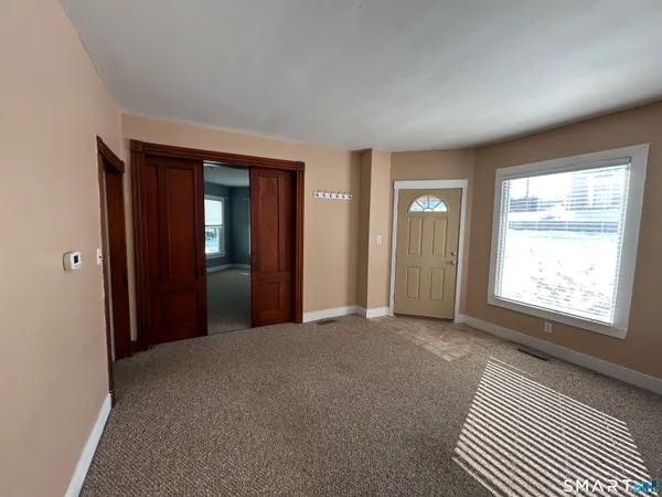 an empty room with windows and closet