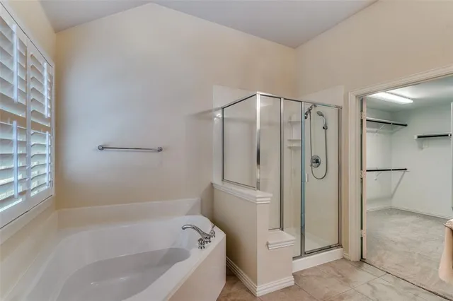 a bathroom with a bathtub and a shower