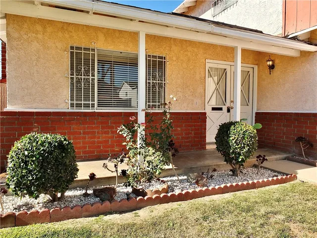 a dining room with furniture a chandelier and window