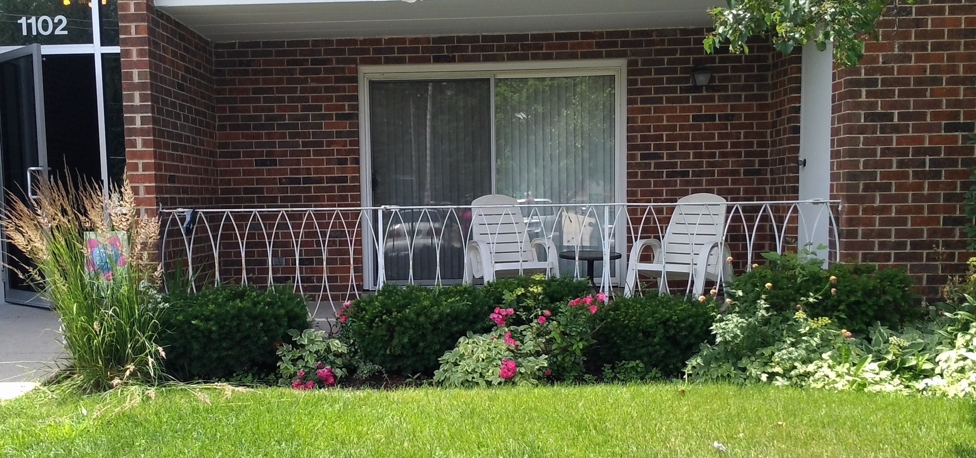 a view of a house with a yard and plants