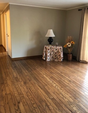 1102 Springinsguth Road, Unit 1A Schaumburg, IL 60193 - Photo 3 of 14 a bed room with a bed and a chair