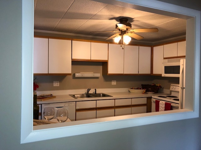 1102 Springinsguth Road, Unit 1A Schaumburg, IL 60193 - Photo 6 of 14 a kitchen with stainless steel appliances a stove a sink and a microwave