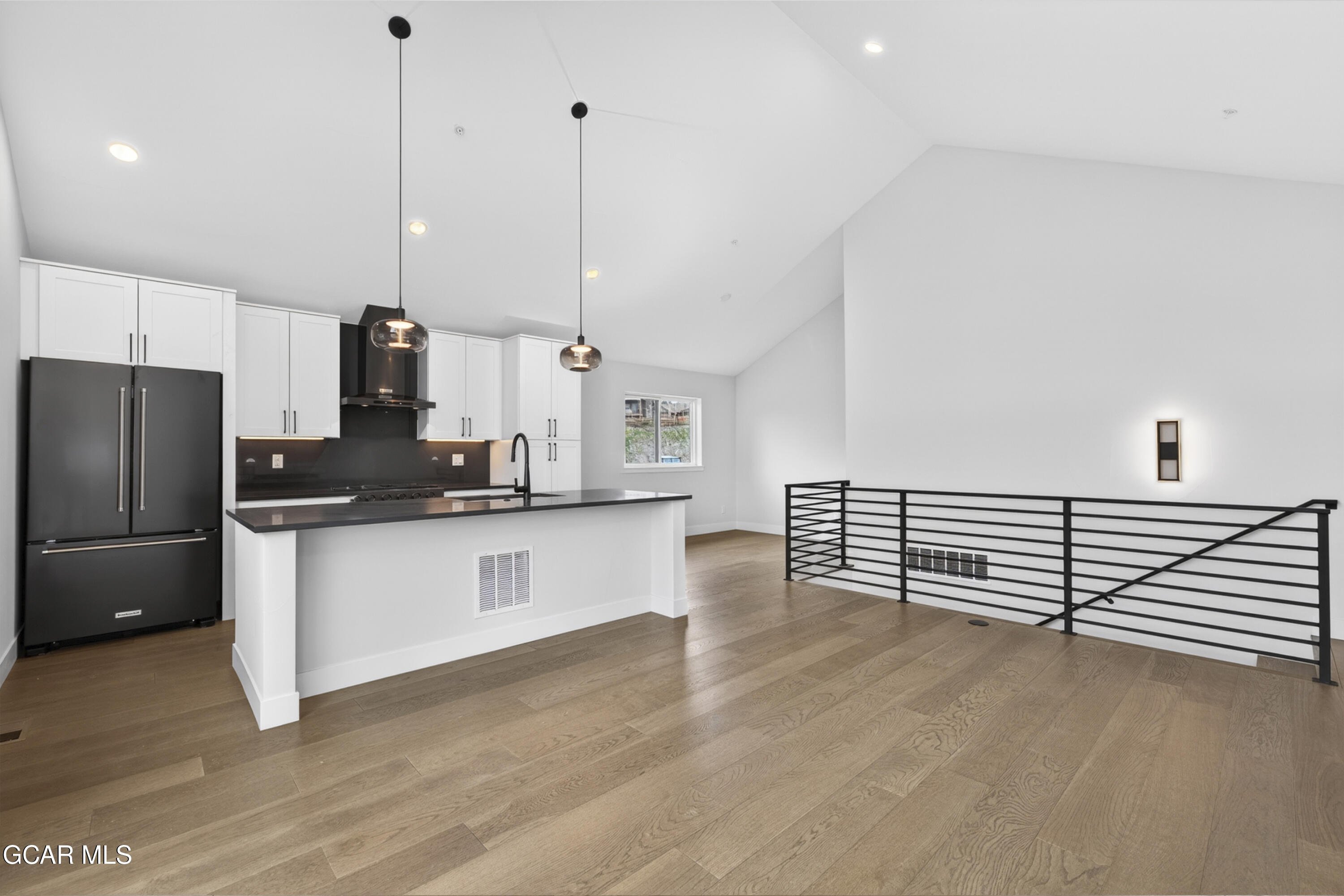 119 Wheeler Road Winter Park, CO 80482 - Photo 11 of 51 a kitchen with stainless steel appliances refrigerator wooden floor dining table and chairs