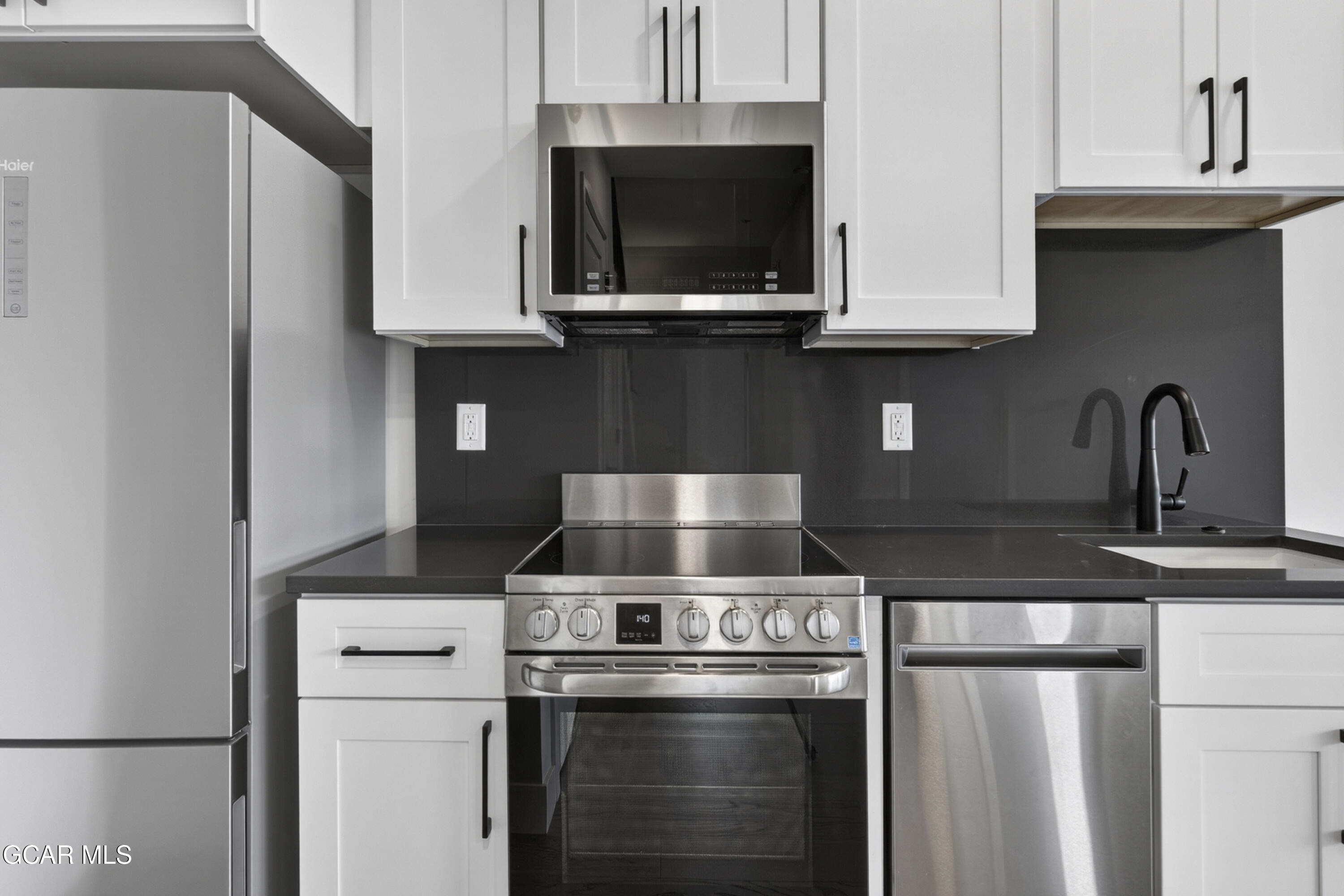 119 Wheeler Road Winter Park, CO 80482 - Photo 40 of 51 a kitchen with stainless steel appliances granite countertop a refrigerator a stove and a sink