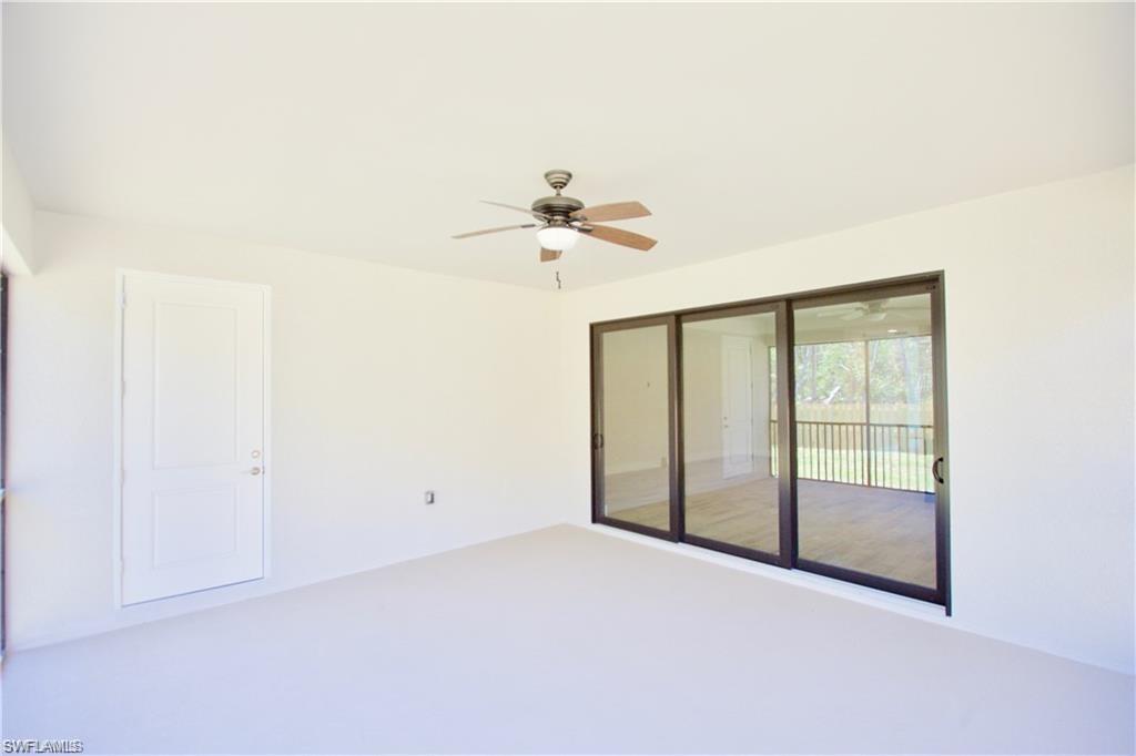 3128 Woodside Avenue Naples, FL 34112 - Photo 15 of 16 an empty room with a ceiling fan and a window