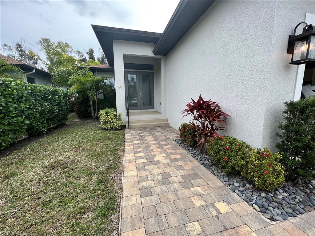 3128 Woodside Avenue Naples, FL 34112 - Photo 2 of 16 a view of a house with a yard