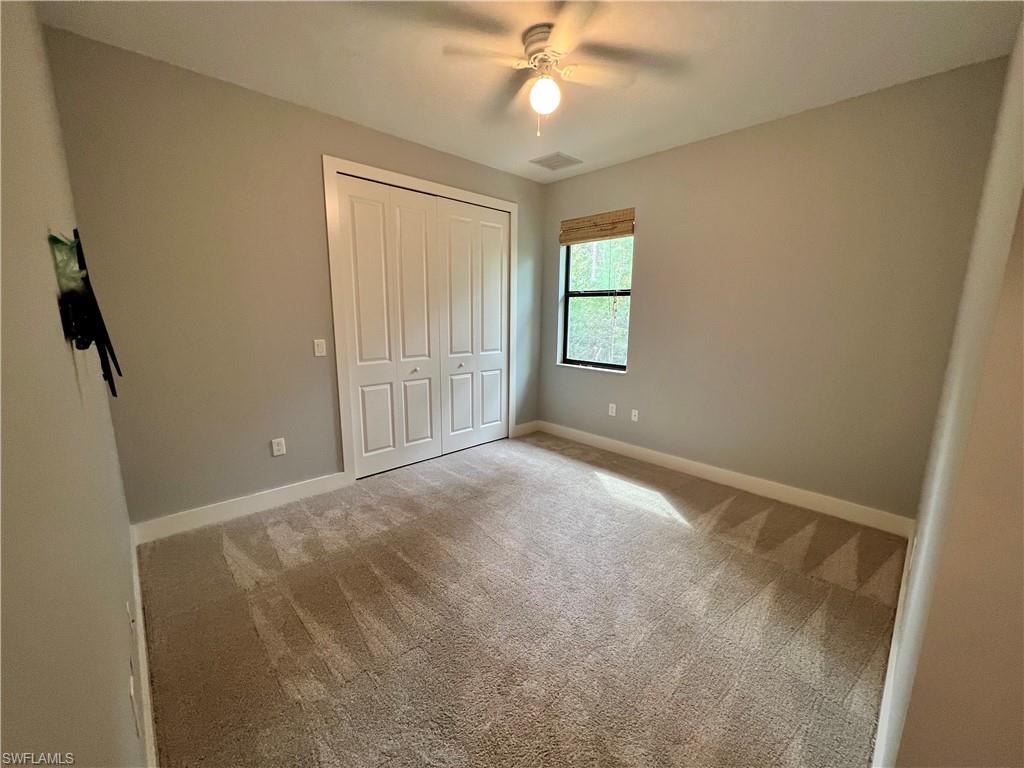 3128 Woodside Avenue Naples, FL 34112 - Photo 10 of 16 an empty room with windows and fan