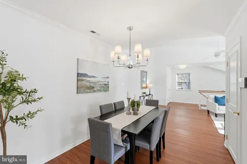 a view of a dining room with furniture wooden floor and chandelier