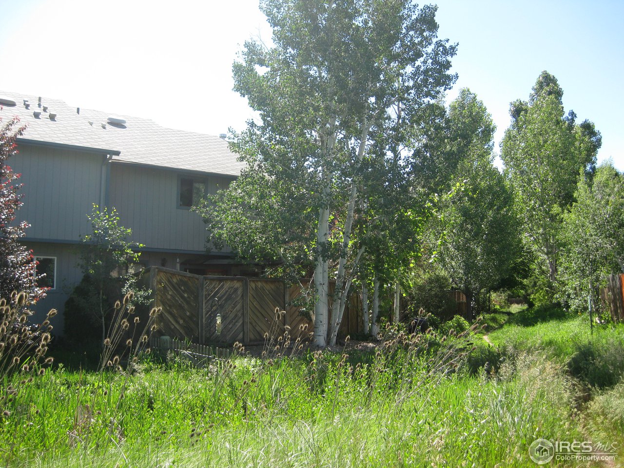 6616 Kalua Road Boulder, CO 80301 - Photo 16 of 18 a backyard of a house with lots of green space